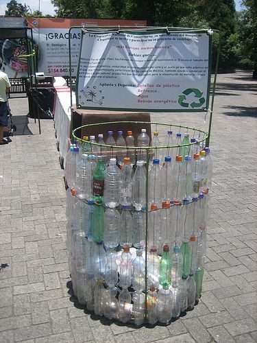 there are many bottles stacked on top of each other in the middle of the street