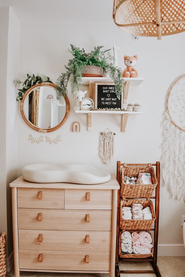 a baby's room with a crib, dresser and mirror