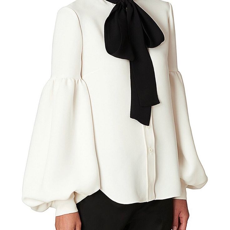 Elegant Silk Blouse Featuring A Contrasting Self-Tie Lavalier Bow At Neck And Voluminous Drop Puff Sleeves. Self-Tie Lavalier Bow At Neck Dropped Shoulders Long Puff Sleeves With Button Cuffs Button Front High-Low Shirttail Hem. Elegant Fitted Blouse With Tie Sleeves, Elegant Office Blouse With Bishop Sleeves, White Tie Neck Blouse For Formal Occasions, Elegant Tops With Blouson Sleeves And Tie Neck, Elegant Fitted Tops With Tie Sleeves, Elegant Puff Sleeve Top With Tie Sleeves, White Tie Sleeves Blouse For Office, Elegant White Padded Blouse, Elegant Formal Tops With Bishop Sleeves