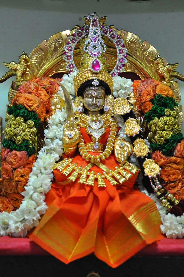 the statue is decorated with flowers and gold