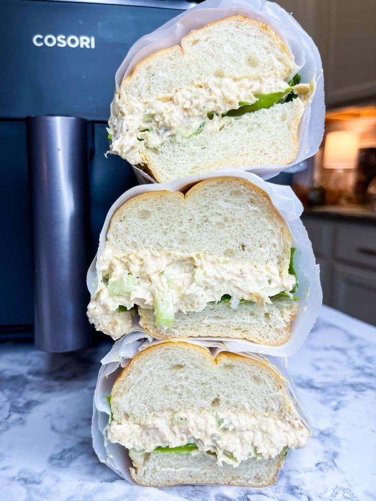 three sandwiches are stacked on top of each other