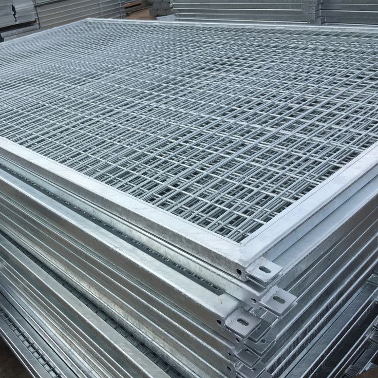 several steel grates are stacked on top of each other in a warehouse or storage area