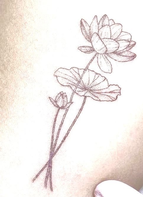 a woman's stomach with a flower tattoo on it