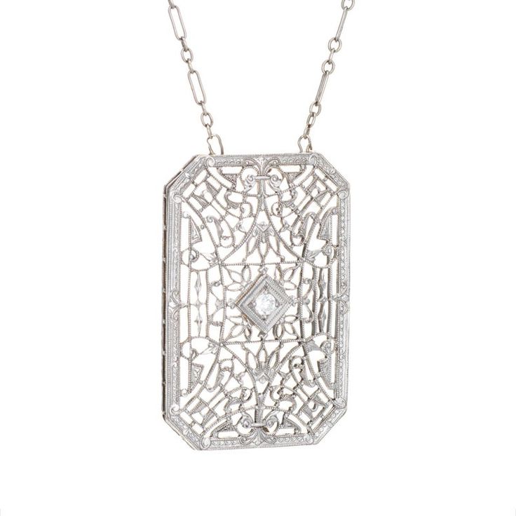 Finely detailed vintage Art Deco drop necklace (circa 1920s to 1930s), crafted in 14 karat white gold.   The drop is set with an estimated 0.04 carat Old European cut diamond (estimated at H-I colour and SI1 clarity).    The die-struck necklace features intricate and lacy filigree detail. The chain is comprised of longer bar links attached to smaller round links. The necklace measures 17 inches and sits nicely at the nape of the neck. The filigree necklace was very popular during the era and is Luxury Filigree Diamond Necklace For Formal Occasions, Elegant Diamond Necklace With Rectangular Pendant For Formal Occasions, Antique White Gold Necklace With Diamond Accents, Antique White Gold Necklace With Intricate Design, Elegant White Gold Filigree Diamond Necklace, Luxury White Gold Diamond Necklace With Filigree, Elegant White Gold Diamond Necklace With Filigree, Elegant Silver Diamond Necklace With Rectangular Pendant, White Gold Diamond Necklace With Filigree