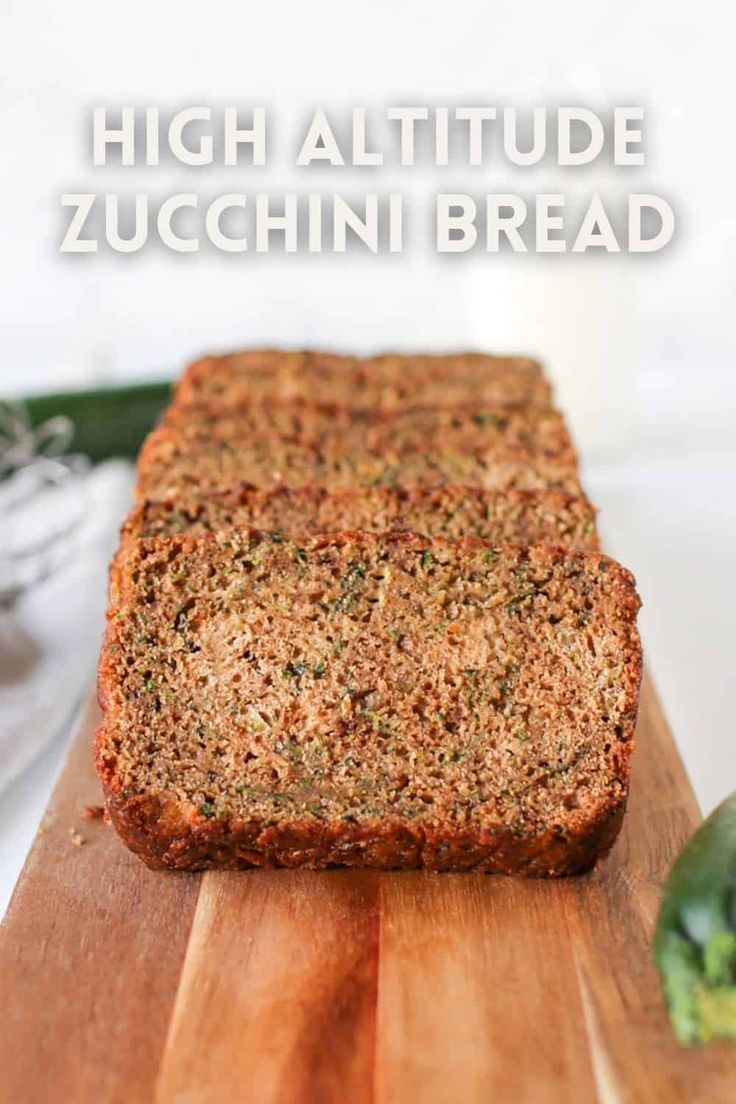 a loaf of zucchini bread sitting on top of a wooden cutting board