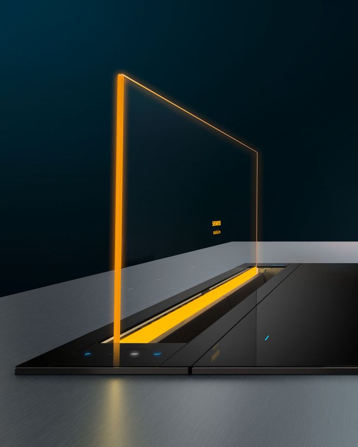 an open laptop computer sitting on top of a metal surface with yellow light coming from it