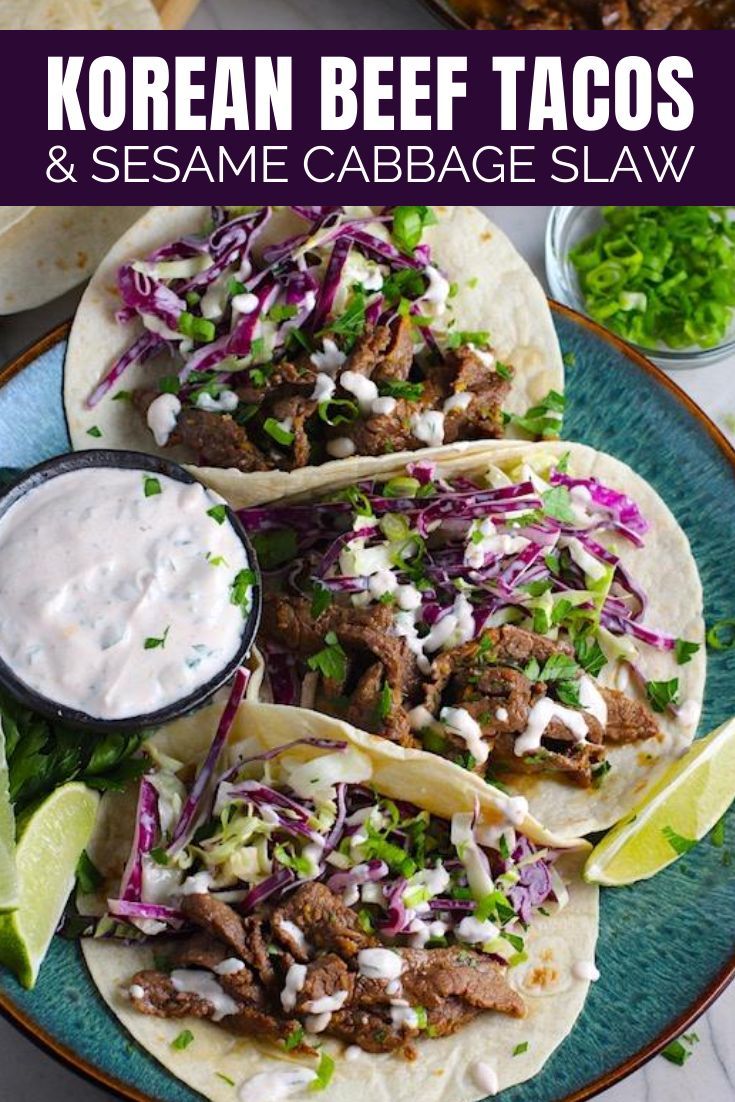 korean beef tacos and sesame cabbage slaw on a blue plate with lime wedges