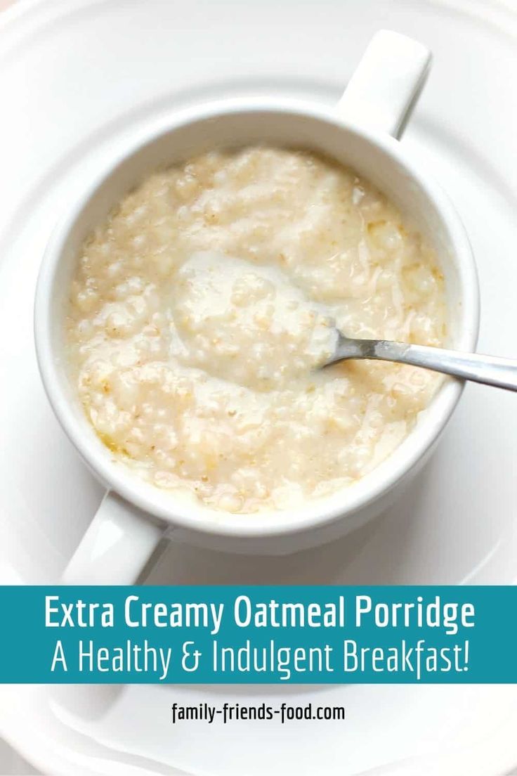 a bowl of oatmeal with a spoon in it on a white plate