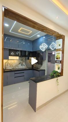 an empty kitchen and living room in a house with blue cabinets, white walls and flooring