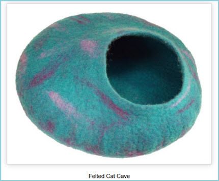 a blue cat ball with pink spots on it's side and the bottom part of its