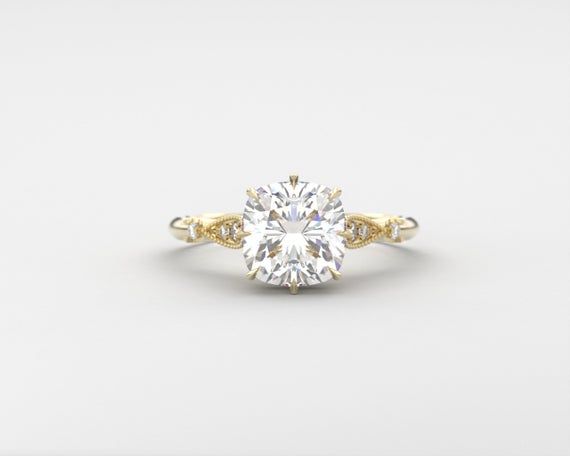 This is an elegant Cushion solitaire ring design with a hidden halo of diamonds and an antique style where the top resembles floral petals holding the center Moissanite.  I used a large 3ct diamond equivalent custom cut moissanite with an under halo of diamonds for the top head flanked by diamonds surrounded by milgrain on a slim dainty band.Ring Features:* Center Stone: Choose from approx. 8mm Cushion brilliant cut; -Ritzy Moissanite colorless, -Neo moissanite colorless-Charles & Colvard Fo Cushion Solitaire Ring, Solitaire Ring Designs, Antique Diamond Ring, Cushion Solitaire, Engagement Ring Cushion, Dainty Band, Engagement Rings Cushion, Ring Cushion, Vintage Engagement Ring