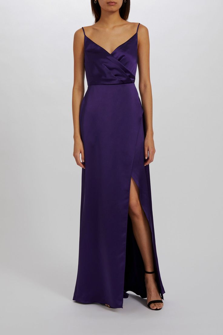 V-neck, faux wrap dress in fluid satin with front split. Shown in Amethyst. V-neck Satin Maxi Dress With Side Slits, V-neck Dress With Side Slits For Evening, Purple Satin Evening Dress, Silk Wrap Dress With Surplice Neckline For Cocktail, Evening Purple Silk Maxi Dress, Purple Silk Evening Maxi Dress, Evening Silk Maxi Dress With Surplice Neckline, Silk Maxi Dress With Surplice Neckline For Evening, Elegant Purple Dress With Satin Finish