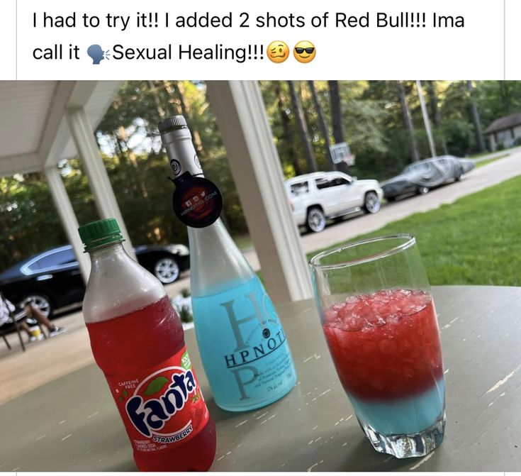 two soda bottles and a glass on a table