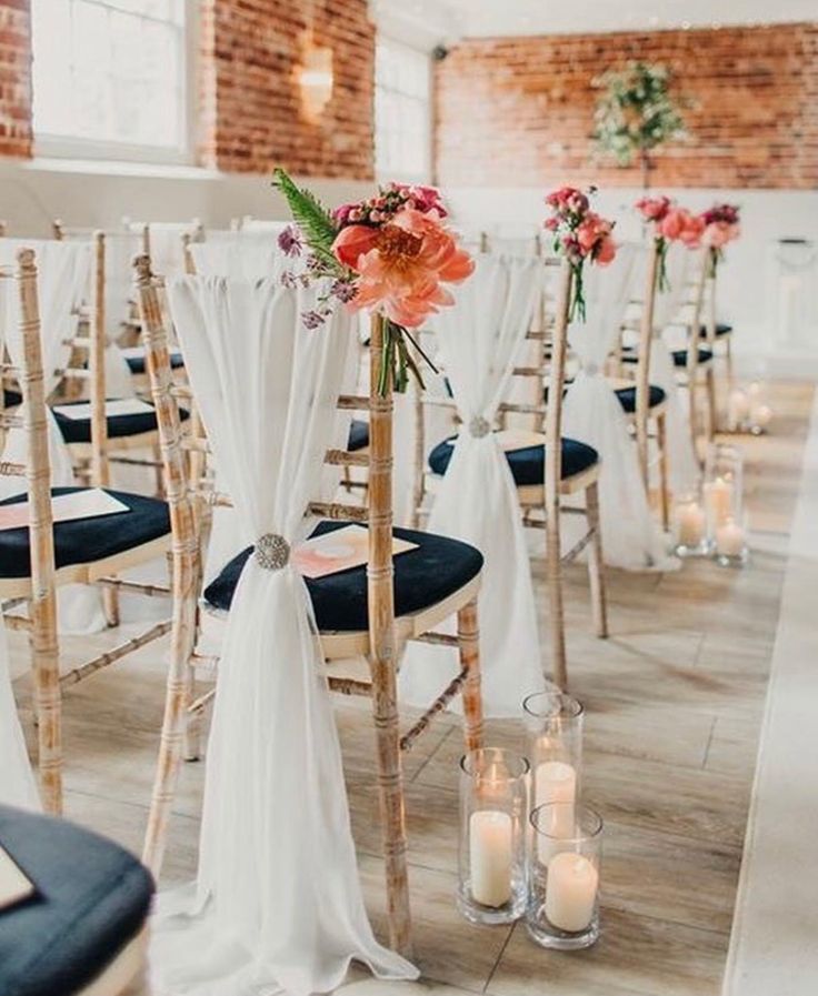 the chairs are decorated with flowers and candles