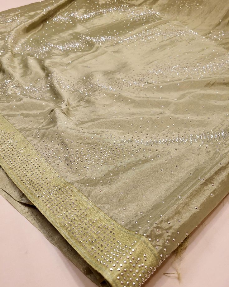 A stunning sage green chiffon saree with beading that can be perfect for any event (receptions, formals, parties, etc.)! This transparent piece has that silky body-hugging effect due to the light weight chiffon material. Blouse material is included (last image) and this saree can also be purchased in baby pink or baby blue! Elegant Pista Green Dola Silk Pre-draped Saree, Silk Saree With Dori Work For Party, Green Mirror Work Blouse Piece For Party, Green Blouse Piece With Mirror Work For Party, Party Green Blouse With Mirror Work, Elegant Green Blouse With Mirror Work, Elegant Green Dola Silk Saree, Green Georgette Party Wear Saree, Elegant Green Saree With Mirror Work