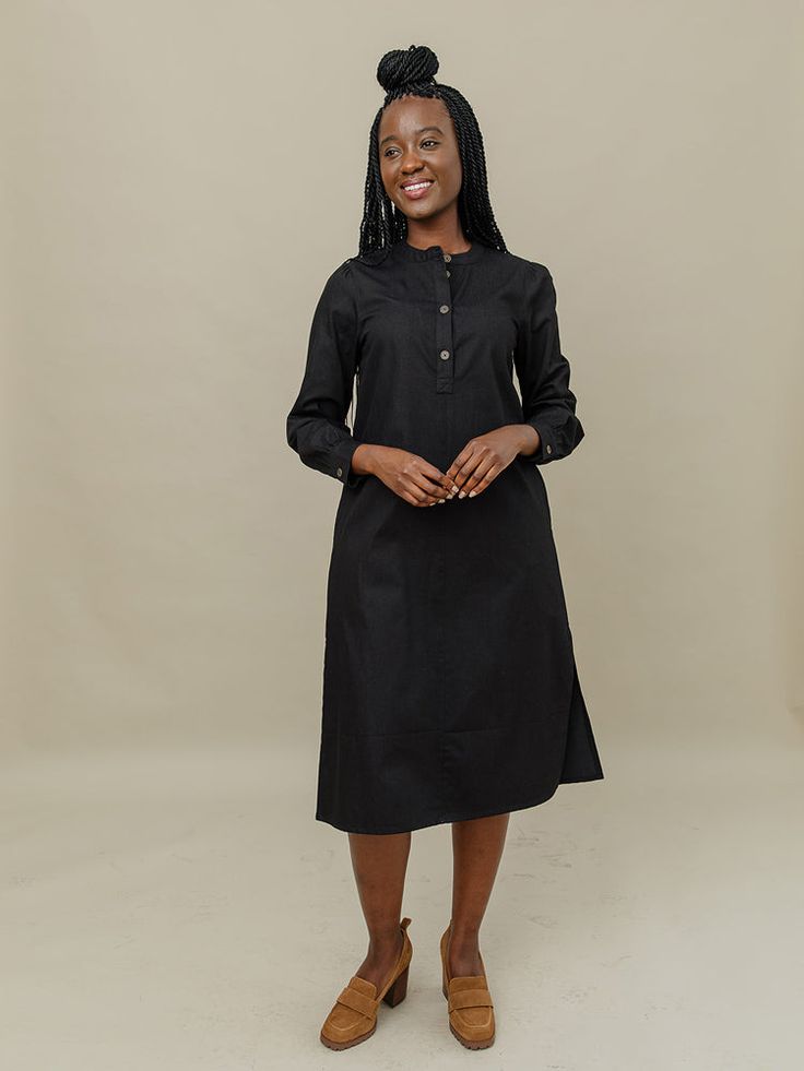 This midi dress will be a staple in your closet. Featuring hidden pockets, brass buttons, and a midi length skirt that hits mid-calf, this black dress is casual cute in canvas-weight denim cotton that's perfect for cooler weather. 100% Cotton Hidden pockets Brass buttons Length of size M is 45.75" from top of bodice Made fair trade in India by one of our longstanding production partners Fair Trade Clothing, Tencel Fabric, Brass Buttons, Midi Dress Black, Midi Length Skirts, Denim Cotton, Cooler Weather, Maxi Wrap Dress, Black Midi Dress