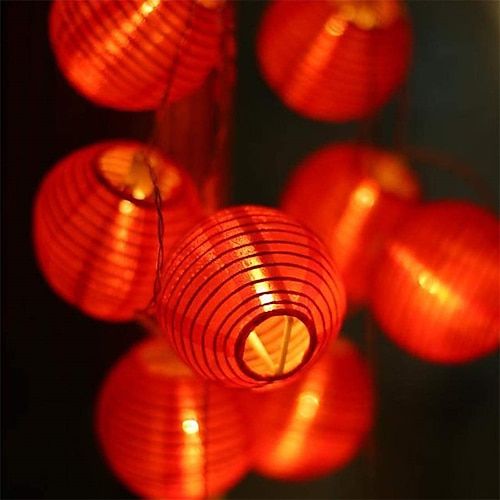 many red lanterns are hanging in the dark