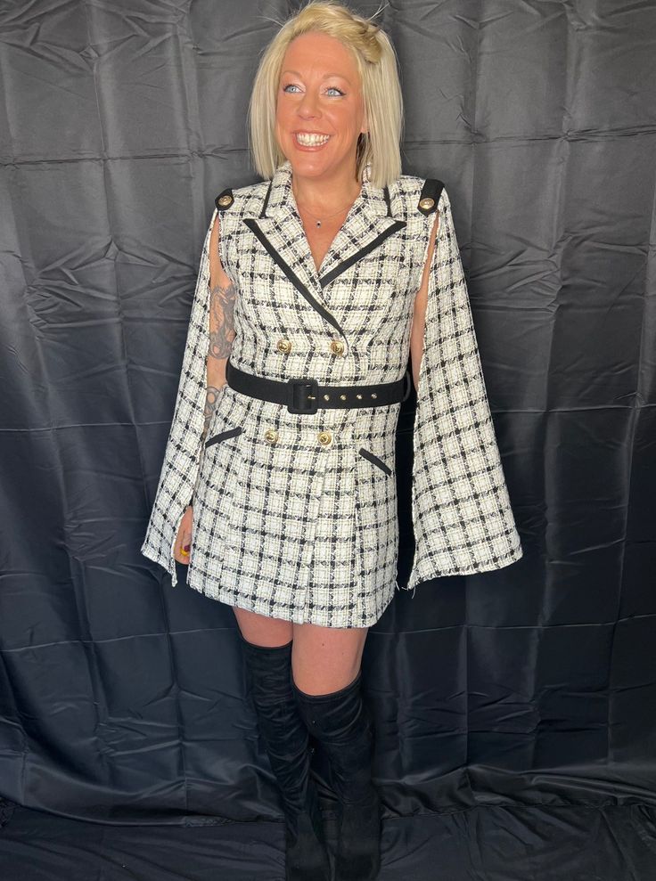 She's truly one of a kind--timeless, classy, and stunning. This is a fabulous quality style to last a lifetime. Super high quality, black, white, and gold plaid, tweed material. Fully lined. Stunning cape style long sleeves take this dress to another level. Shoulder pads, ornate shoulder detail, and edgy collar give this dress a timeless cape silhoette, making her a real standout. Double breasted front closure with statement gold buttons. Black belt included. True to size with no stretch in the Long Sleeve Tweed Dress For Fall, Chic Tweed Dress For Fall Party, Long Sleeve Tweed Dress For Fall Evenings, Long Sleeve Tweed Dress For Evening In Fall, Chic Fall Party Tweed Dress, Evening Long Sleeve Tweed Dress For Fall, Long Sleeve Tweed Dress For Fall Party, Long Sleeve Tweed Party Dress For Fall, Fall Party Long Sleeve Tweed Dress