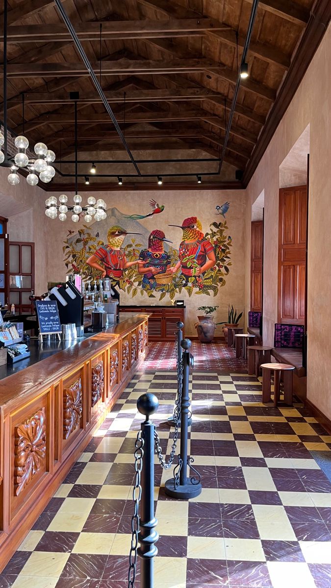 a checkered floor in a restaurant with an art work on the wall