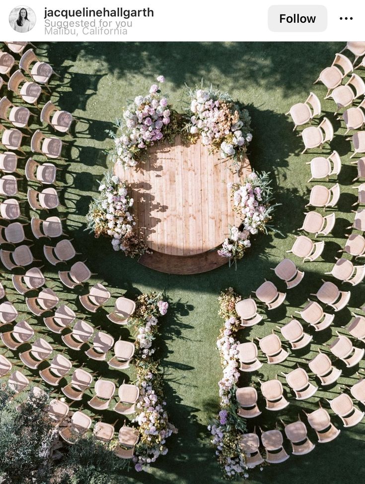 an overhead view of a wedding ceremony setup with chairs and flowers on the floor, surrounded by greenery