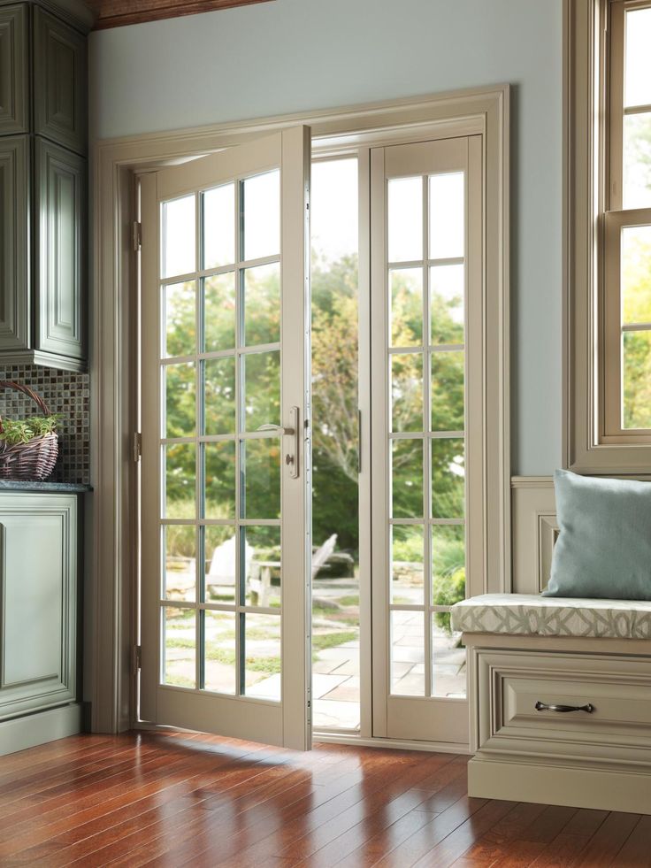 the interior of a home with french doors and wood flooring in front of it