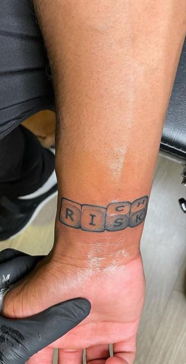 a man with a tattoo on his arm that says rise up and has the word rise written across it