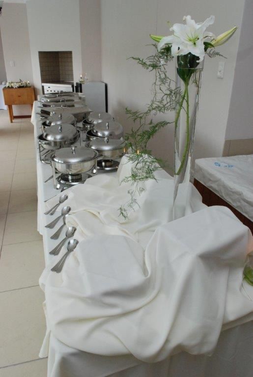 a table with silverware and flowers on it