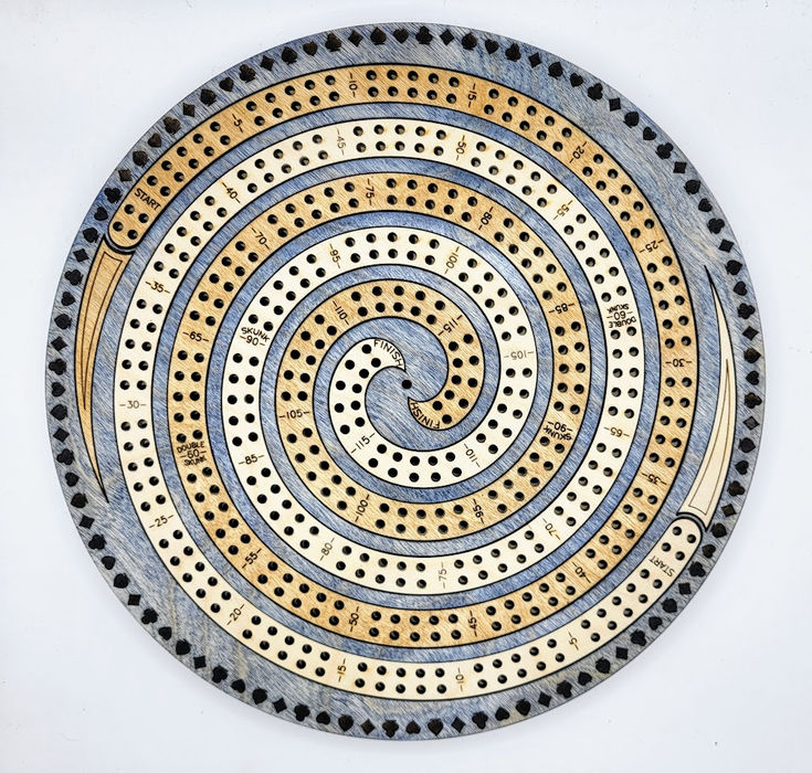 a circular metal object with dots and circles on it's surface, against a white background