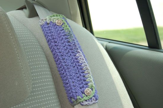 a crocheted neck tie sitting on the back seat of a car