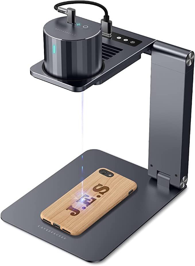 an image of a cell phone on a table with a projector attached to it