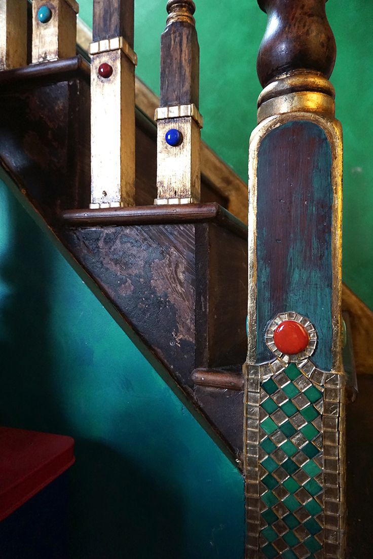 an old wooden stair case with metal handles and knobs