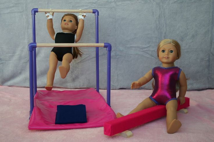 two dolls are playing on a pink trampoline and another doll is sitting in the background