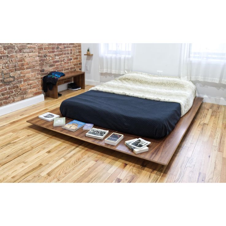 a bed sitting on top of a wooden platform