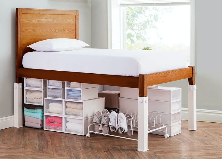 a bed that has some drawers underneath it