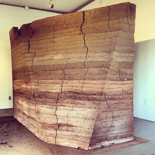 a large piece of rock sitting in the middle of a room next to a fire hydrant