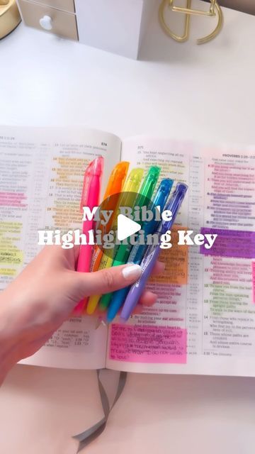 a person holding a book with several pens in it and the title my bible high - flying key