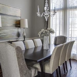 a dining room table with chairs and a chandelier