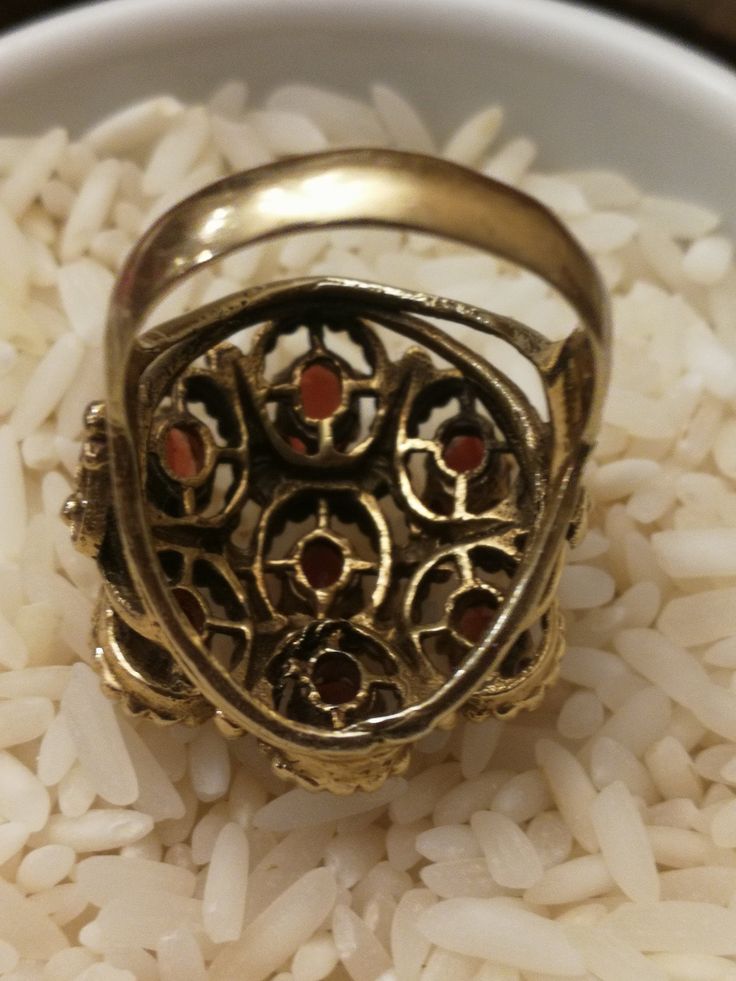 This is the last ring in a set of 5, that I bought in southern Indiana. It's a remarkable Huge 14K ladies Garnet Cluster ring. It weighs a hefty 11.0 grams, and the top measures 24mmx22m. There are 7-6x4mm medium red oval Garnets set with 6 prongs each. There a beaded pattern around each Garnet, and has a scrolled heart design on each side. There are some very fine scratches on a few stones that are considered normal for everyday wear. Its not noticeable unless looking under a 10x loupe. It's a Antique Gold Opal Ring Collectible, Antique Round Enamel Ring For Anniversary, Antique Oval Multi-stone Ring, Antique Hallmarked Opal Ring, Fine Jewelry Collectible Enamel Ring, Collectible Enamel Fine Jewelry Ring, Antique Collectible Enamel Ring, Vintage Gold Enamel Ring With Gemstone, Vintage Gold Multi-stone Cluster Ring