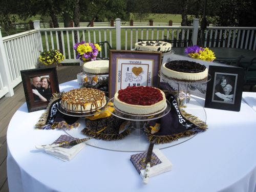 a table topped with cakes covered in frosting and pictures on top of it next to flowers