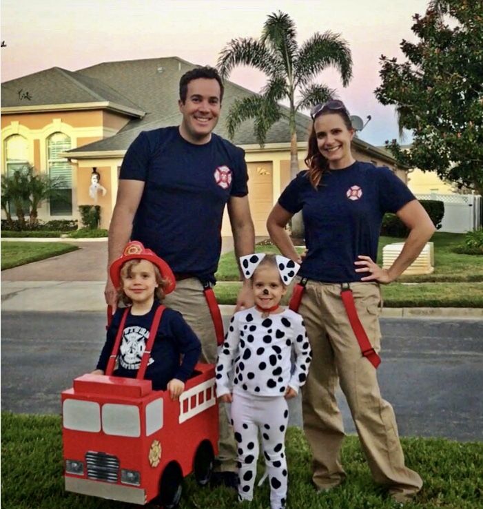 the family is dressed up as dalmatian and his firetruck for halloween