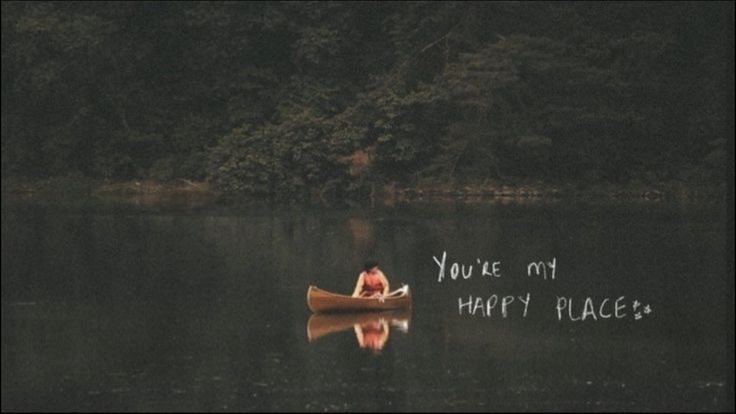 a person in a canoe on a lake with the words you're my happy place