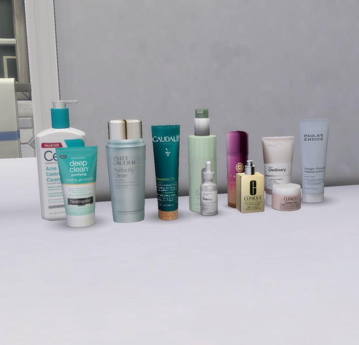 many different types of skin care products lined up on a counter next to a mirror