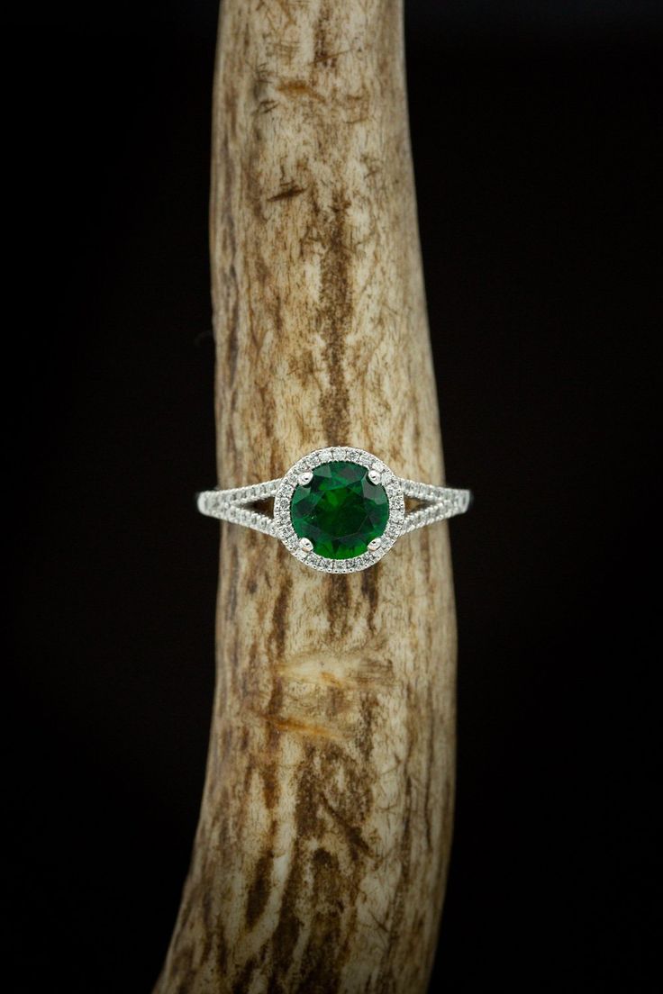 Product Details Ring Style:The "Aura" is a birthstone ring with a split shank-style & lab-created emerald women's ring with delicate and ornate details and is available with many center stone options Center Stone:7mm Round Lab-createdEmerald Materials: 14K gold engagement ring featuring a lab-created emerald center stone and a 1/5 ctw diamond halo and accents. Customizable:Because each of our rings is handcrafted to order, wecan customize yours using unique materials, gemstones, or design fe Heirloom Style Emerald Ring With Halo, Heirloom Emerald Ring With Halo, Halo Diamond Ring For May Birthstone, Halo Design Diamond Ring For May Birthstone, Halo Promise Ring With May Birthstone, May Birthstone Halo Ring For Promise, Green Emerald Jewelry With Halo Detail, Round Cut Emerald Halo Design Jewelry, Green Emerald Halo Jewelry