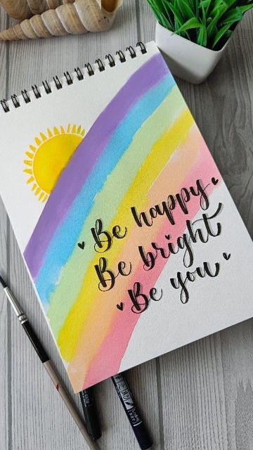 a notepad with the words be happy, bright and you written on it next to a potted plant