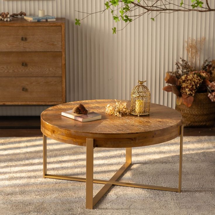 a wooden table sitting on top of a carpeted floor next to a vase with flowers