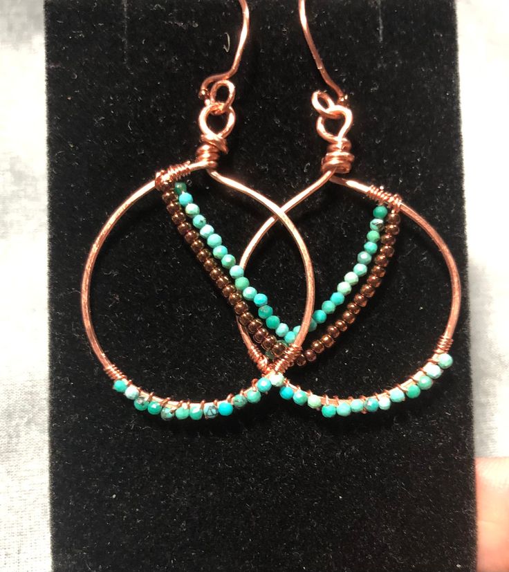 I love turquoise and I also love the warmth of copper. These lightweight (3.6 grams for the pair)  hoops feature itty bitty turquoise beads.  They hang just past two inches and dangle beautifully!  Handmade in a smoke free and pet free home. Handmade Small Hoop Turquoise Beaded Earrings, Adjustable Turquoise Beaded Copper Earrings, Nickel Free Copper Jewelry With Round Beads, Nickel-free Copper Jewelry With Round Beads, Nickel-free Copper Beaded Jewelry, Artisan Small Hoop Copper Jewelry, Turquoise Beaded Copper Earrings, Turquoise Wire Wrapped Dangle Hoop Earrings, Turquoise Dangle Hoop Earrings Wire Wrapped