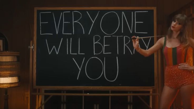 a woman standing in front of a blackboard with writing on it that says everyone will be very you