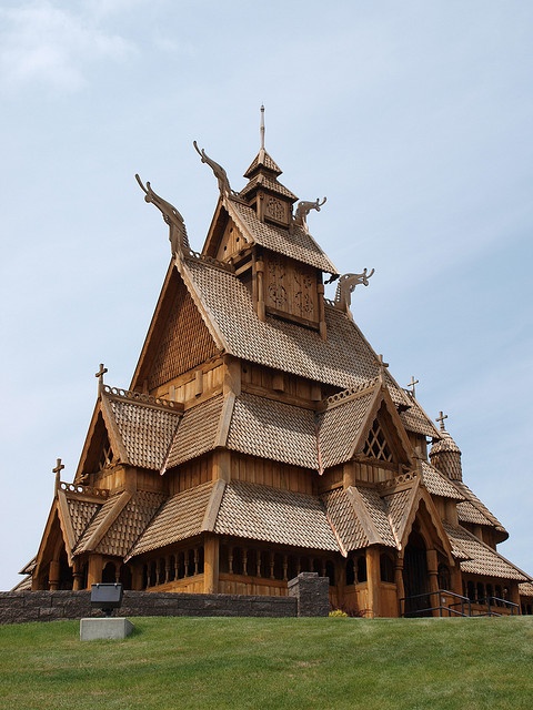 an elaborate wooden building on top of a hill