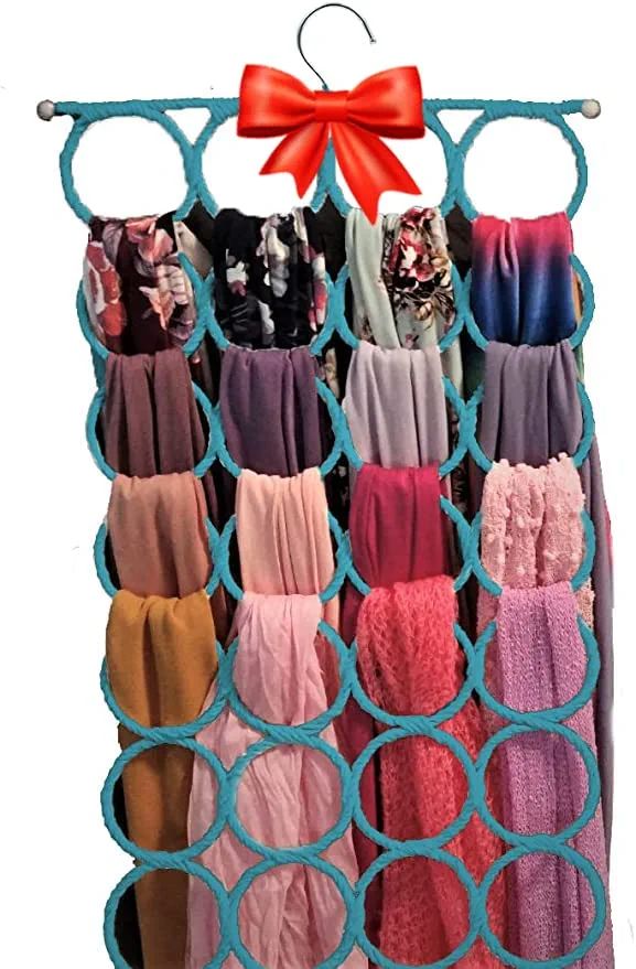 a rack with many different colored pants hanging on it's sides and a red bow at the top