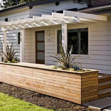 a wooden planter in front of a house